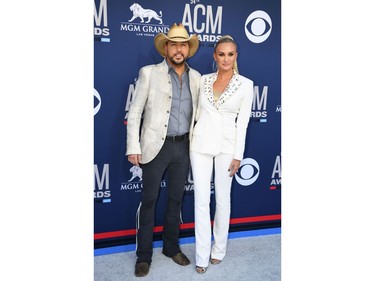 U.S. singer Jason Aldean (L) and wife cheerleader Brittany Kerr arrive for the 54th Academy of Country Music Awards on April 7, 2019, at the MGM Grand Garden Arena in Las Vegas.