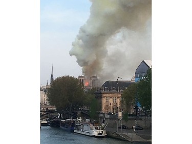 Flames and smoke are seen billowing from the roof at Notre Dame Cathedral in Paris on April 15, 2019.