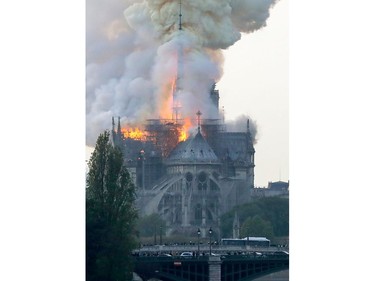 Smokes ascends as flames rise during a fire at the landmark Notre Dame Cathedral in central Paris on April 15, 2019.