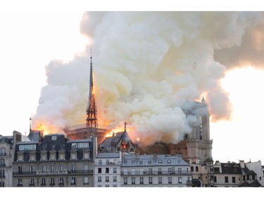 Smoke and flames rise during a fire at the landmark Notre Dame Cathedral in central Paris on April 15, 2019.