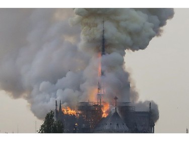 Flames and smoke are seen billowing from the roof at Notre Dame Cathedral in central Paris on April 15, 2019.