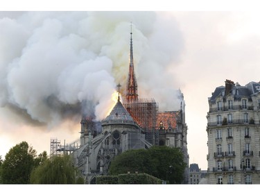Plumes of smoke and flames rise during a fire at the landmark Notre Dame Cathedral in central Paris on April 15, 2019, potentially involving renovation works being carried out at the site, the fire service said. - A major fire broke out at the landmark Notre-Dame Cathedral in central Paris sending flames and huge clouds of grey smoke billowing into the sky, the fire service said. The flames and smoke plumed from the spire and roof of the gothic cathedral, visited by millions of people a year, where renovations are currently underway.