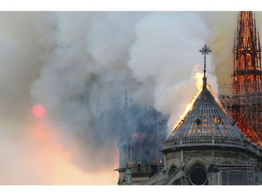 Flames burn the roof of the landmark Notre Dame Cathedral in central Paris on April 15, 2019, during a fire. - A major fire broke out at the landmark Notre-Dame Cathedral in central Paris sending flames and huge clouds of grey smoke billowing into the sky, the fire service said. The flames and smoke plumed from the spire and roof of the gothic cathedral, visited by millions of people a year, where renovations are currently underway.