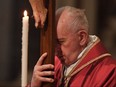 Pope Francis carries a crucifix during the Celebration of the Lord's Passion on Good Friday at St. Peter's Basilica, on April 19, 2019 in the Vatican. (TIZIANA FABI/AFP/Getty Images)