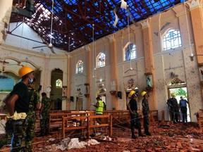 Security personnel inspect the interior of St. Sebastian's Church in Negombo on April 22, 2019, a day after the church was hit in series of bomb blasts targeting churches and luxury hotels in Sri Lanka.  ISHARA S. KODIKARA/AFP/Getty Images