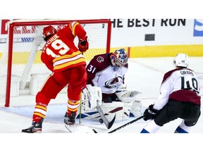Colorado Avalanche goalie Philipp Grubauer makes a save on Matthew Tkachuk of the Calgary Flames late in the third period in Game 2 of the Western Conference First Round during the 2019 NHL Stanley Cup Playoffs at the Scotiabank Saddledome in Calgary on Saturday, April 13.