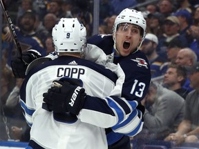 Winnipeg Jets' Brandon Tanev (13) is congratulated by teammate Andrew Copp after scoring during the third period in Game 3 of an NHL first-round hockey playoff series against the St. Louis Blues, Sunday in St. Louis.