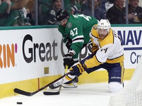 Dallas Stars right wing Alexander Radulov and Nashville Predators defenceman Mattias Ekholm compete for control of the puck in the first period of Game 3 in an NHL hockey first-round playoff series in Dallas, Monday, April 15, 2019.