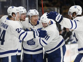Maple Leafs' Auston Matthews (second left) celebrates his goal with teammates during the third period in Game 5 NHL playoff action against the Bruins in Boston, Friday, April 19, 2019.