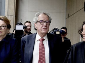 Australian actor Geoffrey Rush, centre, arrives at the Supreme Court in Sydney, Thursday, April 11, 2019. Oscar-winning actor Rush won his defamation case against a Sydney newspaper publisher and journalist over reports he had been accused of inappropriate behavior toward an actress.