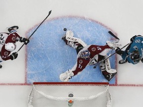 Colorado Avalanche's Ian Cole (28) and goaltender Philipp Grubauer (31) make a save against the San Jose Sharks' Marcus Sorensen (20) in the second period of Game 1 of an NHL hockey second-round playoff series at the SAP Center in San Jose, Calif., on Friday, April 26, 2019.