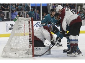 San Jose Sharks left wing Evander Kane, second from right, scores a goal between Colorado Avalanche goaltender Semyon Varlamov, left, and defenceman Tyson Barrie during the first period of an NHL hockey game in San Jose, Calif., Saturday, April 6, 2019.