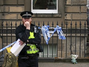 A floral tribute at the scene of the shooting of Trainspotting 2 movie actor Bradley Welsh, in Edinburgh, Scotland, Thursday April 18, 2019.  According to a police statement Welsh died at the scene Wednesday, April 17, and their investigations continue. (Jane Barlow/PA via AP)