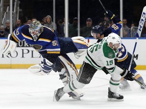 St. Louis Blues goaltender Jordan Binnington is upended by Dallas Stars forward Blake Comeau after Binnington left the net to clear a loose puck in Game 1. The collision led to a melee that could set the tone for the series. (AP)
