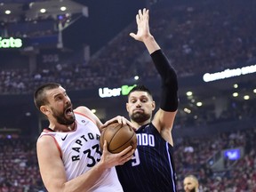 Raptors centre Marc Gasol battles Magic centre Nikola Vucevic for the ball during first half playoff action in Toronto on Tuesday THE CANADIAN PRESS/Frank Gunn