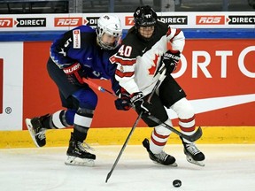 Megan Keller of the U.S., left, and Blayre Turnbull of Canada in action during the 2019 IIHF Women's World Championships preliminary match in Espoo, Finland, Saturday April 6, 2019.