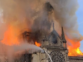 Flames and smoke are seen billowing from the roof at Notre Dame Cathedral in Paris on April 15, 2019