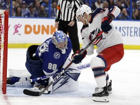 Columbus Blue Jackets right wing Cam Atkinson, right, scores around Tampa Bay Lightning goaltender Andrei Vasilevskiy during the first period of Game 2 of an NHL Eastern Conference first-round hockey playoff series Friday, April 12, 2019, in Tampa, Fla.