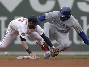 Toronto Blue Jays' Teoscar Hernandez, right, steals second base as the ball gets away from Boston Red Sox second baseman Dustin Pedroia during the seventh inning in Boston on Tuesday. (AP Photo/Charles Krupa)