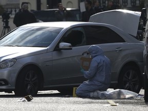 A Forensic officer works at the scene near the Ukrainian Embassy after police fired shots after an incident, in Holland Park, London, Saturday April 13, 2019.