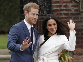 In this Monday, Nov. 27, 2017 file photo, Britain's Prince Harry and his fiancee Meghan Markle pose for photographers during a photocall in the grounds of Kensington Palace in London.