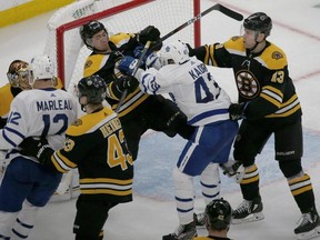 Bruins defenceman Connor Clifton (centre) and Maple Leafs centre Nazem Kadri (second right) shove each other at the goal during the third period of Game 2 of an NHL first-round playoff series, Saturday, April 13, 2019, in Boston.