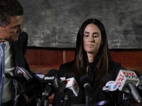 Attorney Garo Mardirossian, left, pats the back of former sports reporter Kelli Tennant before the start of a news conference, Tuesday, April 23, 2019, in Los Angeles.