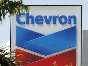 This Aug. 20, 2012, file photo, shows a Chevron sign in Miami. A Northern California jury ordered Chevron Corp. to pay the families of two brothers a combined $21.4 million after they claimed the men's exposure to a toxic chemical while working at a company plant caused the cancer that killed them. The San Francisco Chronicle reported that The Contra Costa County jury's verdict Friday, March 29, 2019. Brothers Gary Eaves and Randy Eaves worked at a Chevron-owned tire manufacturer in Arkansas.