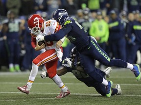 In this Dec. 23, 2018, file photo, Kansas City Chiefs quarterback Patrick Mahomes is tackled by Seattle Seahawks defensive end Frank Clark, right, during the second half of an NFL game, in Seattle.