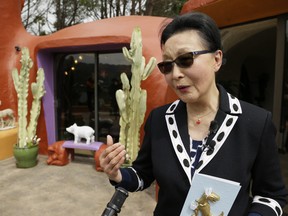 Florence Fang talks with reporters after a news conference outside her Flintstone House Thursday, April 11, 2019, in Hillsborough , Calif. (AP Photo/Eric Risberg)