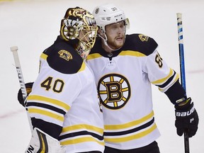 Bruins goaltender Tuukka Rask (left) and teammate David Pastrnak (right) celebrate defeating the Maple Leafs in NHL playoff action in Toronto on Wednesday, April 17, 2019.