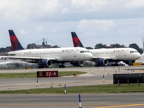 In this Aug. 8, 2017 file photo, Delta Air Lines airplanes line the tarmac ahead of a groundbreaking ceremony of the construction on Delta Air Lines $4 billion, 37-gate facility at LaGuardia Airport. (AP Photo/Mary Altaffer, File)
