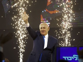 Israel's Prime Minister Benjamin Netanyahu waves to his supporters after polls for Israel's general elections closed in Tel Aviv, Israel, Wednesday, April 10, 2019.