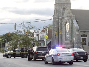 Police work near the scene where authorities say several people were shot, at least one fatally, Sunday, April 28, 2019, in Baltimore. (AP Photo/Steve Ruark)