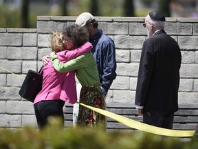 Synagogue members console one another outside of the Chabad of Poway Synagogue Saturday, April 27, 2019, in Poway, Calif. (AP Photo/Denis Poroy)