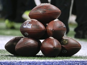 A stack of footballs wait to be used before the NFL Super Bowl 53 football game between the Los Angeles Rams and the New England Patriots Sunday, Feb. 3, 2019, in Atlanta.