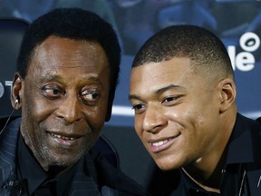 Brazilian soccer legend Pele, left, and French soccer player Kylian Mbappe pose during a photocall in Paris, Tuesday, April 2, 2019. (AP Photo)