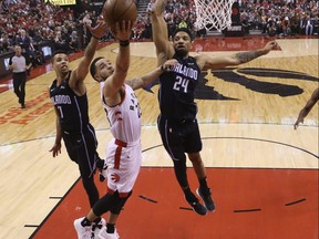 Raptors’ Fred VanVleet goes up for a layup as Orlando Magic’s Michael Carter-Williams (left) and Khem Birch defend during Game 5 on Tuesday night at Scotiabank Arena.