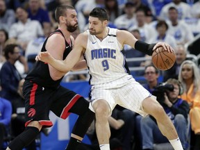 Raptors’ Marc Gasol defends against Magic’s Nikola Vucevic during Game 3 on Friday night in Orlando. (AP PHOTO)
