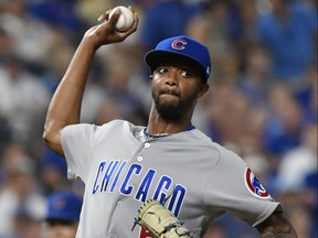 Chicago Cubs Carl Edwards Jr. throws to first on a pick off attempt on Adalberto Mondesi of the Kansas City Royals in the seventh inning at Kauffman Stadium on August 7, 2018 in Kansas City, Missouri. (Ed Zurga/Getty Images)