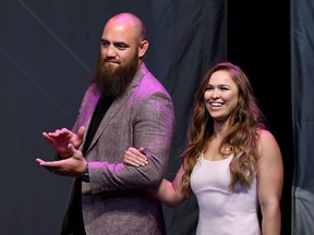 Travis Browne walks onstage with Ronda Rousey as she becomes the first female inducted into the UFC Hall of Fame at The Pearl concert theatre at Palms Casino Resort on July 5, 2018 in Las Vegas, Nevada.  (Ethan Miller/Getty Images)