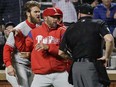 Philadelphia Phillies manager Gabe Kapler, centre, restrains Bryce Harper, left, while arguing a call with umpire Mark Carlson during the fourth inning of a baseball game Monday, April 22, 2019, in New York.