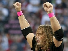 In this March 28, 2010, file photo, Bret "Hit Man" Hart celebrates his victory over Mr. McMahon at WrestleMania XXVI in Glendale, Ariz. Hart was tackled by a spectator Saturday, April 6, 2019, while he was giving a speech during the WWE Hall of Fame ceremony at Barclays Center. The attacker was promptly subdued by several people, including other wrestlers, who came to Hart's defense. Hart is okay.