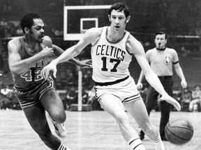 In this Jan. 8, 1970 file photo, Boston Celtics' John Havlicek protects the ball with his body from Atlanta Hawks' Walt Hazzard during an NBA game in Boston.