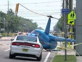 Video screenshot of a helicopter after it crashed onto a street near Tampa, Fla.