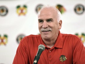 In this July 21, 2017 file photo, Chicago Blackhawks' head coach Joel Quenneville speaks at a news conference during the NHL hockey team's convention in Chicago. Quenneville - who is second on the NHL's all-time victory list - was hired Monday to coach the Florida Panthers.