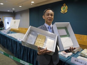 Head of Customs Drug Investigation Bureau Hui Wai-ming holds the seized cocaine during a news conference in Hong Kong, Thursday, April 4, 2019.