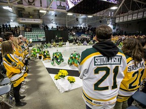 Family members and community members join in a moment of silence during the Humboldt Broncos memorial service at Elgar Petersen Arena in Humboldt, Saskatchewan on Saturday, April, 6, 2019.