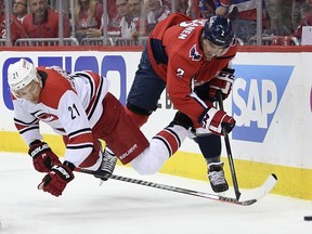 Carolina Hurricanes right wing Nino Niederreiter (21) falls to the ice next to Washington Capitals defenceman Matt Niskanen (2) during Game 2 Saturday, April 13, 2019, in Washington.