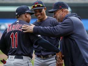 Cleveland Indians manager Terry Francona, right, greets Jose Ramirez (11) with Leonys Martin (2) during introductions at a game against the Minnesota Twins Thursday, March 28, 2019, in Minneapolis.